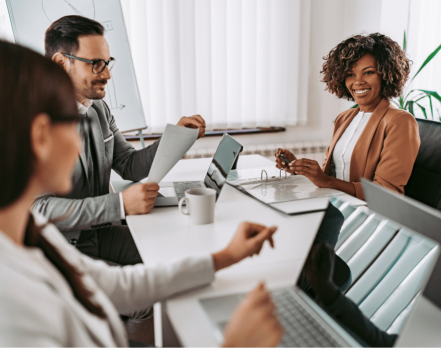 People in a business meeting, smiling.