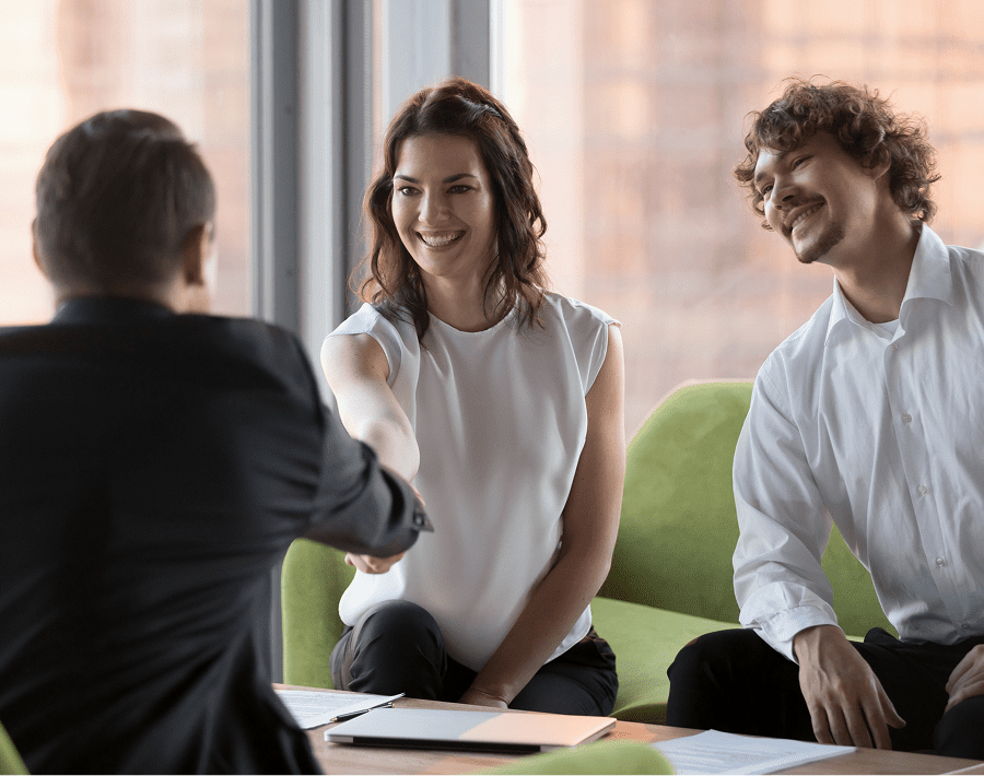 People shaking hands in a business meeting.