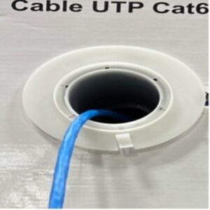 Blue Cat6 UTP cable inserted through a white circular wall plate.
