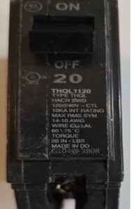 A close-up of a circuit breaker with specifications and ratings.