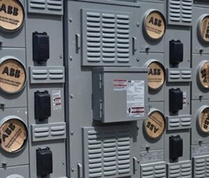 Close-up of a gray electrical control panel with labeled meters and switches.