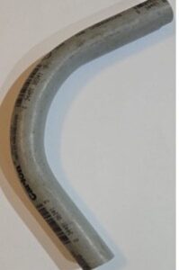 Close-up of a transparent curved tube with residue inside.