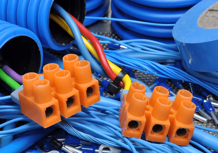 Close-up of blue cables and orange wire connectors.